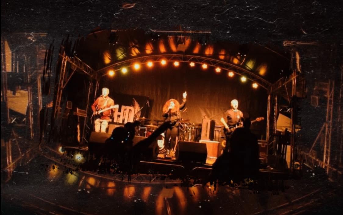 2HD performing to a crowd under warm stage lights