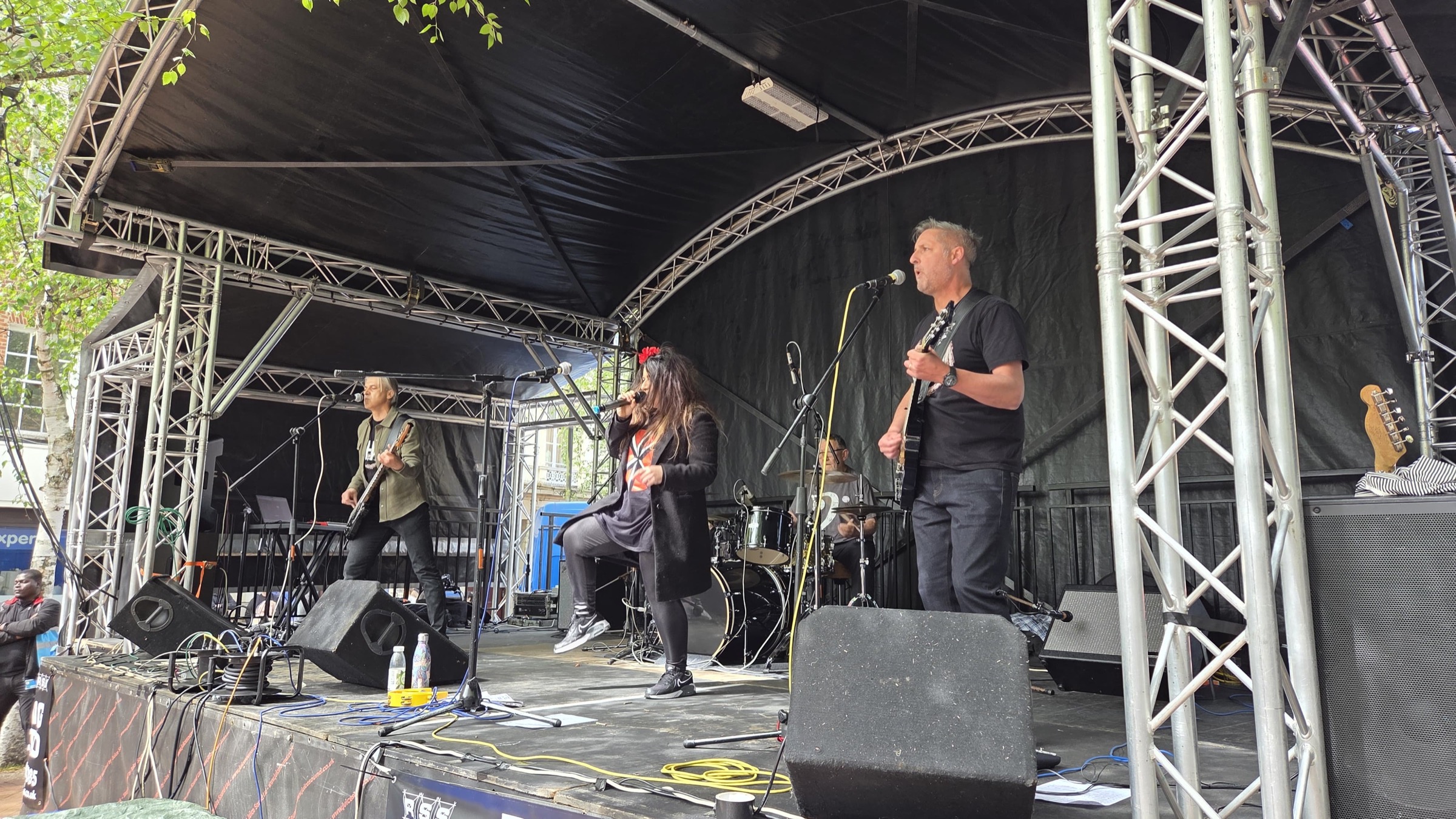 2HD giving an energetic full-band performance on an outdoor stage